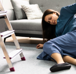 woman falling off of ladder